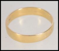 A hallmarked 18ct gold band ring. Hallmarked for Sheffield. Weight 2.3g. Size P.