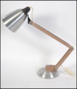 A 1970's polished steel and faux wood Terence Conran ' Mac Lamp ' Polished steel base and shade