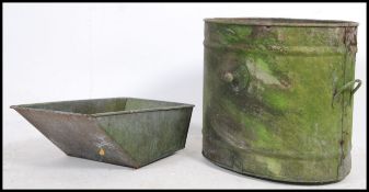 A large early 20th century Industrial galvanised metal water tank of oval form with shaped sides -