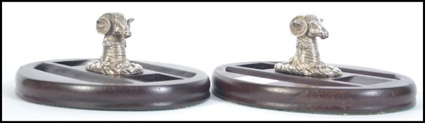 A pair of 20th century hard wood desk tidies with silver plated rams head to the centre of each.