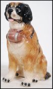 A large ceramic floor standing figurine of a St Bernards dog complete with barrel.