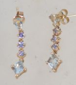 A pair of 9ct gold amethyst and topaz drop earrings. Marked 9K KN. Tests 9ct gold. Weight 2.2g.