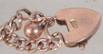 An early 20th century 9ct gold childs bracelet having a 9ct gold padlock clasp.