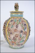 A stunning 20th century majolica style studio pottery lamp. Measures 34cms high.