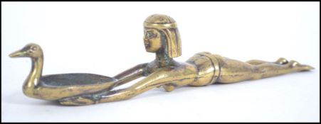 A late 19th century early 20th century bronze oil lamp in the form of an scantily clad Egyptian
