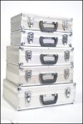 A stack of 5 20th century aluminium aircraft style / camera cases luggage sets all of graduating
