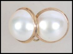 A pair of 18ct gold and baroque pearl screw back earrings.