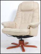 A 20th century leather swivel armchair ( Ekornes Stressless style ) being raised on a wooden base