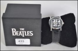 The Beatles - A boxed The Beatles collectors watch featuring all four band members pictured to the