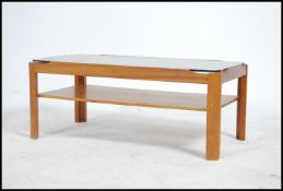 A 1970's retro Myer teak and smoked glass coffee table of rectangular form