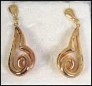 A pair of hallmarked 14ct gold earrings in an abstract twist design. Import mark for Sheffield.