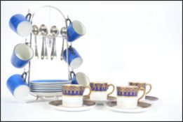 A vintage 20th century set of coffee cans on a silver plated stand with six matching tea spoons by