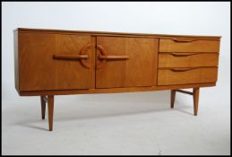 A 1970's retro Danish influenced teak wood sideboard raised on tapered legs with wide bow front