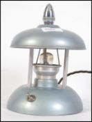 A 1930's Art Deco night light having enamel painted frame with chrome swivel finial controlling