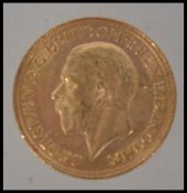 Coins. A George V gold Sovereign, 1929, St George and the Dragon to verso. Total weight 7.
