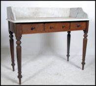 A Victorian mahogany and marble top washstand - writing table desk having mahogany turned legs with