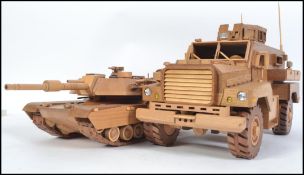 An impressive hand carved and crafted wooden large American armoured vehicle being detailed