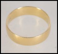 A hallmarked 18ct gold wide band ring. Hallmarked for Sheffield. Weight 3.6g. Size R.