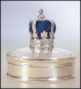 An unusual silver pin cushion and ring box of circular form,