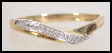 A 9ct gold and diamond band ring. Diamond approx 13pts. Size U.5.