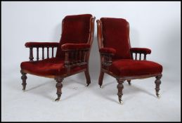 A pair of Victorian mahogany and red velour upholstered ladies and gentlemans armchairs.
