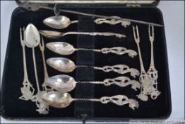 A cased set of six Malaysian silver ( tested ) tea spoons with decorative sea creature handles
