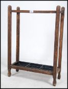 An Edwardian / 20th century two divisional oak stick / umbrella stand of simple form retaining both