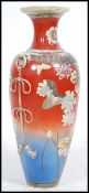 A tall early 20th century Japanese floor standing vase / stick stand having blue and red ground and