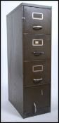 A mid century Industrial thin military green upright filing cabinet having 4 drawers with loop