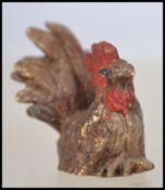 An unusual believed 20th century small miniature bronze figurine of a rooster in the manner of