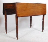 A Victorian mahogany pembroke dining table being raised on turned legs with drop leaves raised on