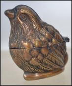A brass cased vesta in the form of a wren / small bird having hinged centre. Measures 4cms high.