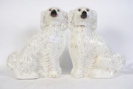 A pair of 19th century large Staffordshire dogs having gilded finish and painted eyes.
