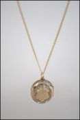 A fine 9ct gold chain and yellow metal Edwardian locket.