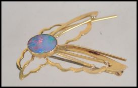 A 9ct gold and opal ladies brooch in the form of a dragonfly.