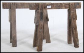 A pair of mid century wooden Industrial Military coffin stands - trestle ends.