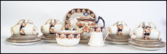 A good Imari early 20th century Staffordshire part tea service together with a similar Imari