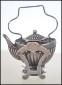 A hallmarked silver miniature spirit kettle and burner / charm. Unusual, with removable base.