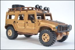 An impressive large hand carved and crafted wooden American 4x4 off road HumVee jeep being fully