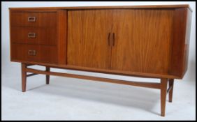 A 1960's retro mid century teak wood tambour front sideboard raised on tapered legs with tambour