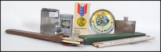 A collection of items to include a French over sized table petrol lighter,