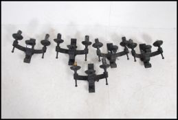 A collection of medieval style strap metal twin head wall lights,