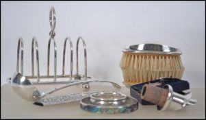 A collection of silver and silver plated items to include a continental silver comb holder,