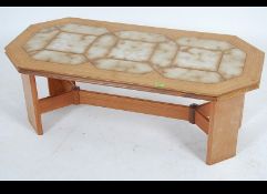 A 1970's G-Plan teak wood and tile top rectangular coffee table of canted form with united central