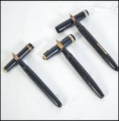 A group of four vintage 20th century fountain / Ink pens to include lever fill pens such as a