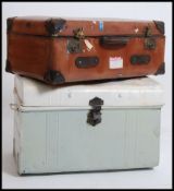 A vintage metal steamer / tack trunk having a hinged top together with a good leather travel trunk