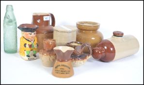 A collection of 19th and 20th century Bristol stoneware's to include harvest jugs, bed warmer,