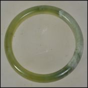 A 20th century Chinese spinach jade bangle of rounded form. Please see images.