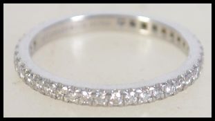 A 950 platinum and diamond Tiffany and Co eternity ring. Size K.5. Total weight 2.4g.