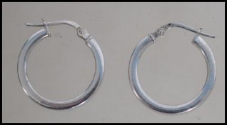 A pair of hallmarked 9ct white gold hoop earrings with lever clasps. Weight 1g.